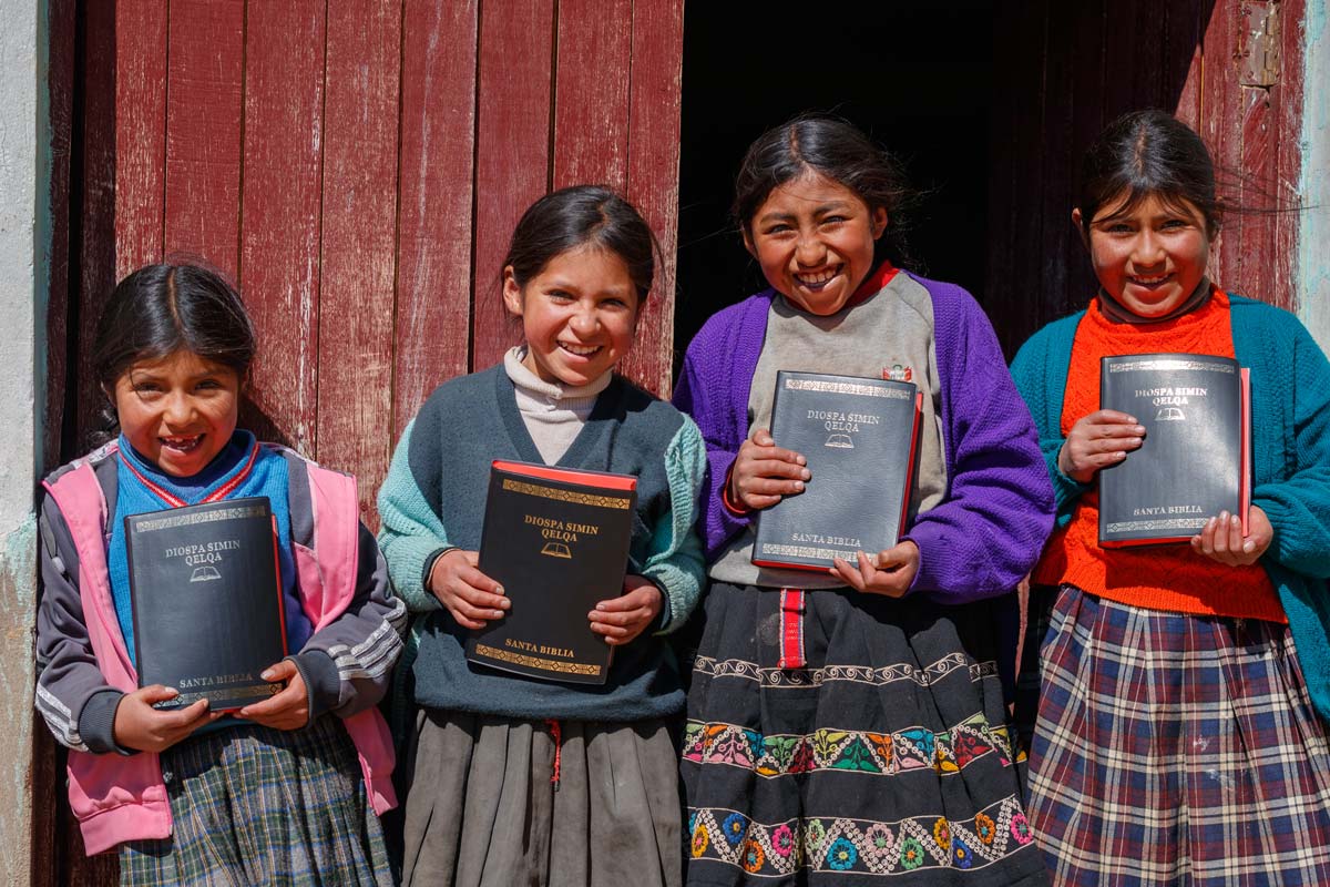 In Peru, girls holding Quechua Bibles